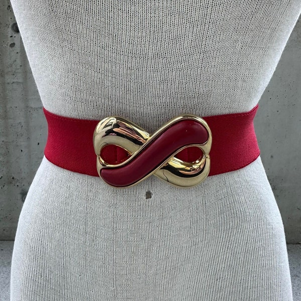 80s Day Lor belt, vintage red elastic belt, chunky gold tone and red leather infinity buckle, maximalist sophisticated fashion statement