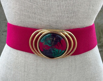 80s pink elastic belt, hot pink stretch waistband, multicolor marbled buckle, ladies fashion statement, maximalist style, dollcore aesthetic