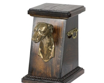May include: A dark wood urn with a brass dog head sculpture on the front. The urn has a brass handle on the side and a rope-like trim around the base.