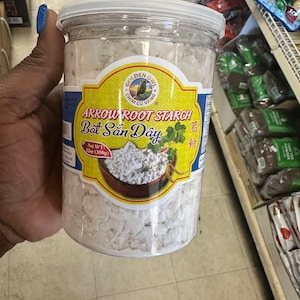 May include: A clear plastic jar filled with white arrowroot starch. The label is yellow with a red border and features a golden owl logo. The text on the label reads "Golden Owl, Chim Cu Vang, Arrow Root Starch, Bot San Day, 葛粉, Net WT: 12oz (350g)"