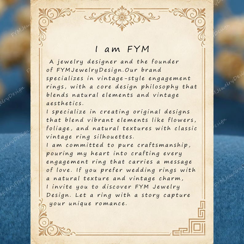 May include: Cream-colored card with ornate borders and text. The text reads "I am FYM," followed by a description of a jewelry designer specializing in vintage-style engagement rings with natural elements and vintage aesthetics.