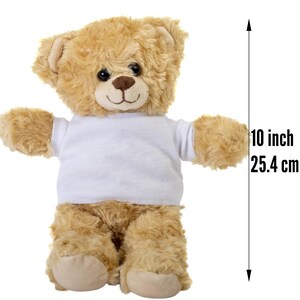 May include: A brown teddy bear wearing a white t-shirt. The bear is 10 inches tall.