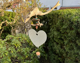 Handmade wind catcher, decorative wind chime made of natural driftwood and decorative beads, as a decoration for hanging in the living room and garden