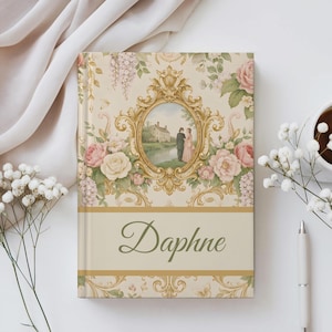 May include: A hardcover book with a cream-colored cover featuring a central gold ornate oval frame enclosing a scene of two figures near a house. The background has floral patterns in pink and green, and the name Daphne is printed in green script.