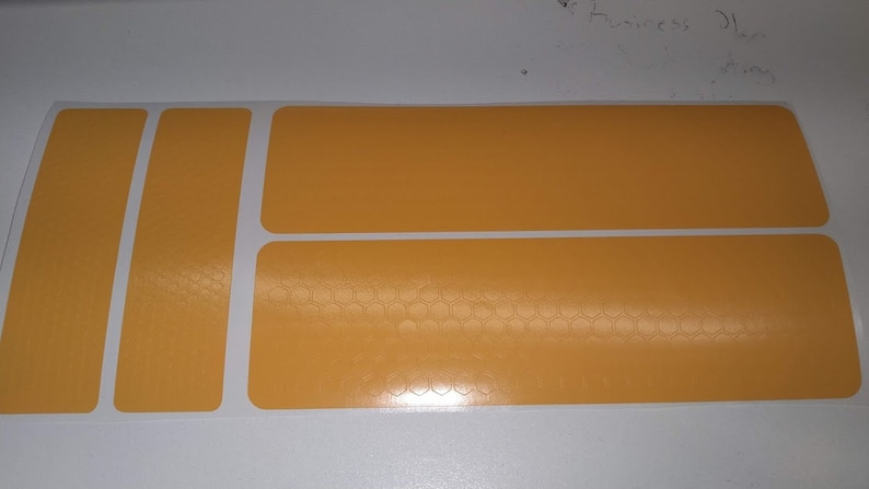 May include: A sheet of yellow adhesive labels with a honeycomb pattern. The labels are rectangular and come in various sizes.