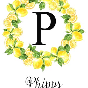 May include: A watercolor design featuring a lemon wreath encircling a large black letter "P". The name "Phipps" is written in cursive below, with "EST 2020" underneath. The wreath includes whole and sliced lemons with green leaves.