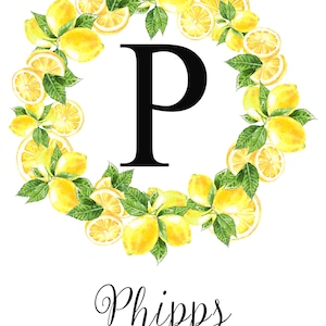 May include: A watercolor design featuring a black letter "P" surrounded by a wreath of lemons and green leaves. The name "Phipps" is written below the letter in cursive, with "EST 2020" underneath.