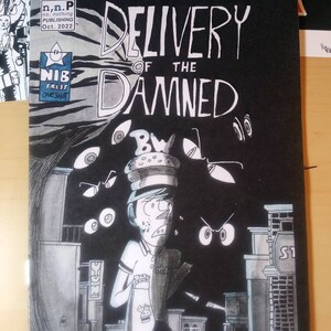 May include: Black and white comic book cover with the title "Delivery of the Damned". The cover features a man in a white shirt and a hat, running through a dark city street with glowing eyes in the background.