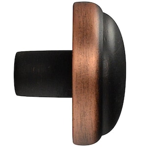 May include: A black and copper cabinet knob with a rounded top and a flat base.