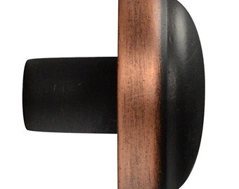 May include: A black and copper cabinet knob with a rounded top and a flat base.