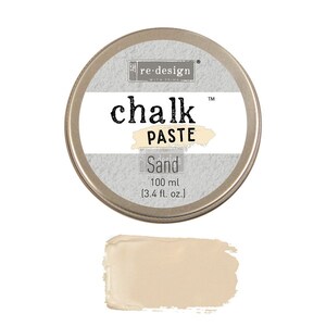 May include: A round tin of re-design with prima chalk paste in the color Sand. The tin is silver with a white label that says "re-design with prima chalk paste" and "Sand". The tin contains 100 ml (3.4 fl. oz.) of paste.
