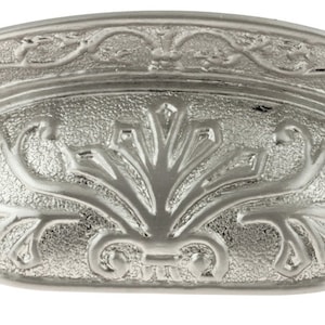 May include: Silver cabinet pull with an ornate floral design.