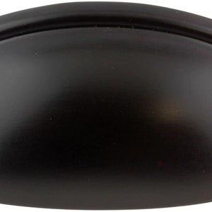 May include: Black cup-shaped cabinet pull with a rounded edge.