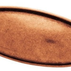 May include: A copper-toned oval cabinet pull with a slightly raised center and a smooth, slightly textured finish.