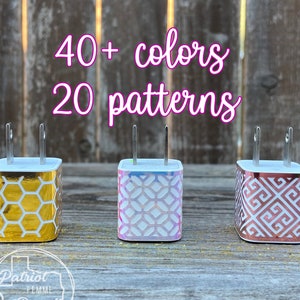 May include: Three decorative phone chargers with patterned designs. One charger has a gold honeycomb pattern, another has a pink and blue geometric design, and the third has a copper-colored geometric pattern. The image includes the text "40+ colors, 20 patterns."