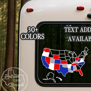 May include: A decal of the United States map with states colored in red, white, blue, and gray, applied to a vehicle window. Text on the window reads "30+ COLORS" and "TEXT ADD-ON AVAILABLE". The decal has a white outline.
