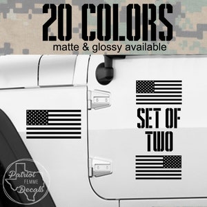 May include: Black and white American flag decals, sold as a set of two. The decals are displayed on a white vehicle door. Text on the image reads "20 COLORS" and "matte & glossy available."