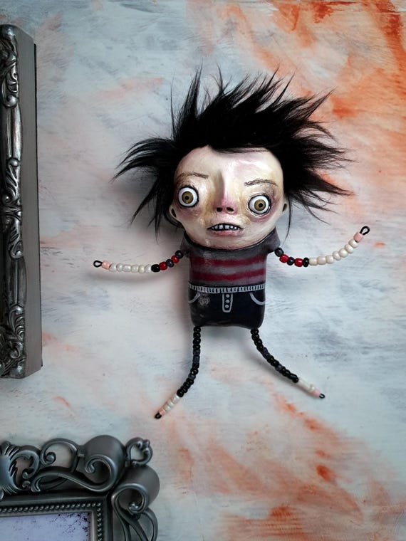 A hand-beaded hanging oddity figure with creepy-cute articulated limbs — the kind of thing you'd find in a Victorian curiosity cabinet and immediately need to own.