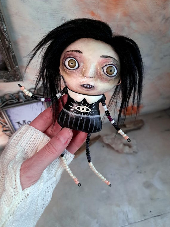 A one-of-a-kind beaded art doll sculpture that lives somewhere between folk art, outsider art, and gothic nightmare — no two are alike and a real person made every bead.