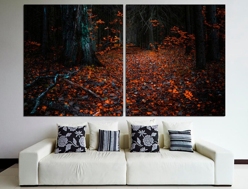 May include: A split canvas print of a dark forest path covered in fallen orange leaves. The path leads into the woods, with tall trees on either side. The image is dark and moody, with a sense of mystery.