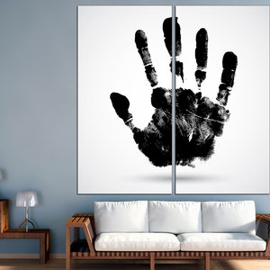 May include: A black handprint on a white background. The handprint is split in half by a vertical line, creating a two-panel art piece.