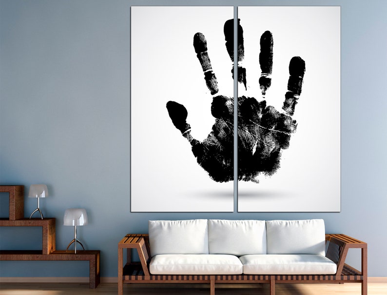 May include: A black handprint on a white background. The handprint is split in half by a vertical line, creating a two-panel art piece.