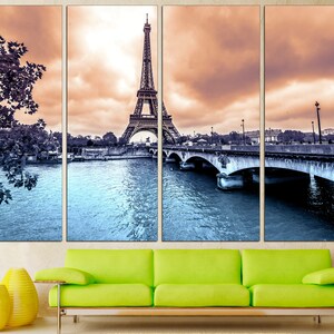 May include: A multi-panel canvas print featuring a black and white image of the Eiffel Tower in Paris, France. The tower is reflected in the water of the Seine River, and a bridge is visible in the foreground.