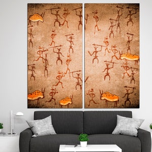 May include: A split canvas print depicting a cave painting of stick figures hunting animals. The figures are brown and the animals are orange. The background is a textured brown.