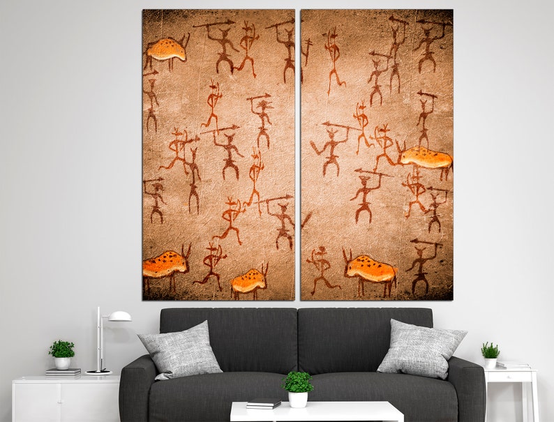May include: A split canvas print depicting a cave painting of stick figures hunting animals. The figures are brown and the animals are orange. The background is a textured brown.