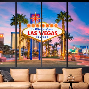 May include: A multi-panel canvas print featuring the iconic "Welcome to Fabulous Las Vegas Nevada" sign at dusk. The sign is illuminated with warm lights, set against a backdrop of palm trees, buildings, and a colorful sky.