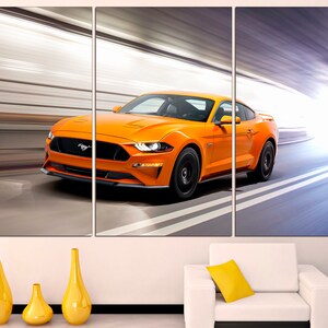 May include: A bright orange Ford Mustang sports car speeding through a tunnel. The car is in motion, with blurred lines of light behind it.