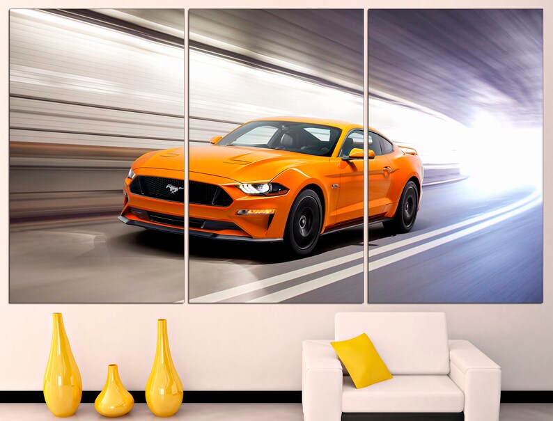 May include: A bright orange Ford Mustang sports car speeding through a tunnel. The car is in motion, with blurred lines of light behind it.
