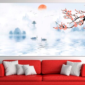 May include: A watercolor painting of a misty mountain landscape with a red sun in the sky. The mountains are reflected in the water, and there are two small boats on the water. A branch of pink blossoms hangs over the scene.
