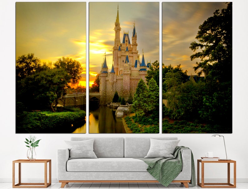 May include: A fairytale castle bathed in the golden light of sunset, surrounded by verdant trees and a reflective lake. The castle features multiple towers and spires, and the sky is a vibrant orange and yellow.