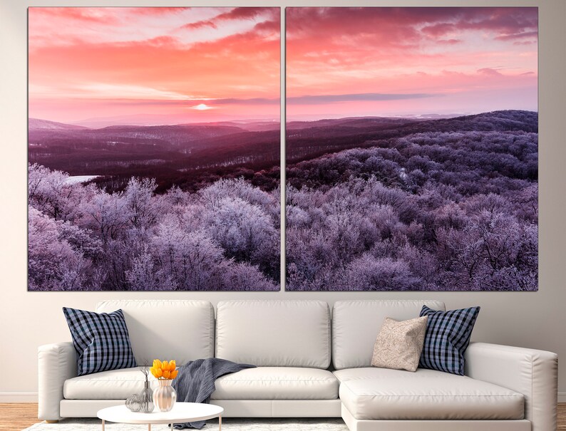 May include: A panoramic view of a winter forest at sunrise. The trees are covered in frost and the sky is a vibrant pink and orange.