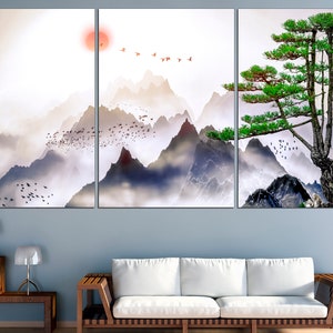 May include: A three-panel canvas print featuring a misty mountain landscape with a lone pine tree on a rocky cliff. The mountains are painted in shades of blue and gray, with a soft, ethereal glow. The pine tree is a vibrant green, with its branches reaching out towards the sky. The print is a beautiful and serene depiction of nature.