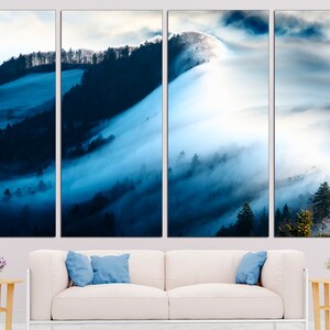 May include: A panoramic view of a misty forest with rolling hills and a blue sky. The fog is thick and white, creating a dreamy and ethereal atmosphere.
