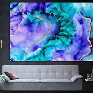 May include: Abstract art print featuring a vibrant blend of colors. The artwork showcases a mix of blues, teals, and purples with gold accents. The fluid design creates a dynamic and visually appealing piece, perfect for adding a modern touch to any space.