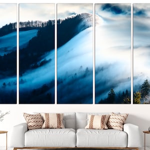 May include: A panoramic view of a misty forest with rolling hills and trees. The fog is thick and white, creating a dreamy and ethereal atmosphere. The colors are mostly blue and white, with hints of green in the trees.