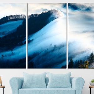 May include: A panoramic view of a misty forest with rolling hills and a blue sky. The fog is thick and creates a sense of mystery and tranquility.