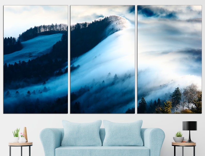 May include: A panoramic view of a misty forest with rolling hills and a blue sky. The fog is thick and creates a sense of mystery and tranquility.