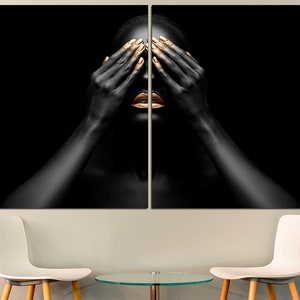 May include: A black and gold portrait of a person with their hands covering their eyes. The person's lips are painted gold.