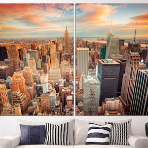 May include: A panoramic view of the New York City skyline at sunset, with tall skyscrapers and a golden sky.