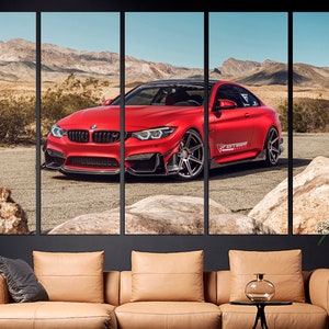 May include: A red BMW M4 sports car with black accents and the text "FERRARI" on the side, parked in a desert landscape.