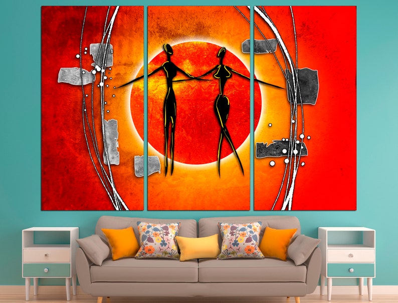 May include: Abstract art print featuring two stylized figures in black against a red and orange background with a large orange circle in the center.