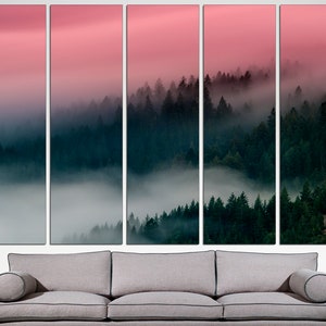 May include: A panoramic view of a misty forest with a pink sky in the background. The trees are densely packed and the fog creates a sense of mystery and tranquility.
