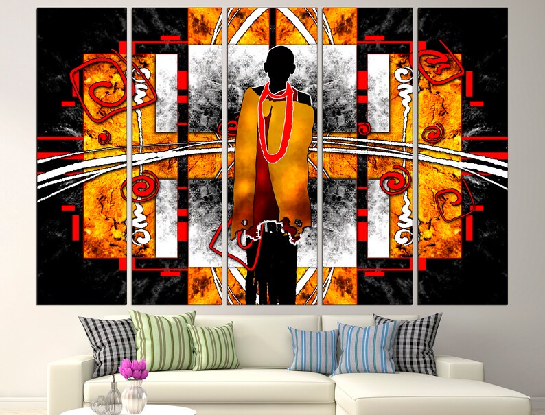 May include: Abstract art canvas print featuring a silhouetted figure with a yellow and red garment. The artwork has a geometric design with black, white, and orange elements. The canvas is displayed above a white sofa with decorative pillows.