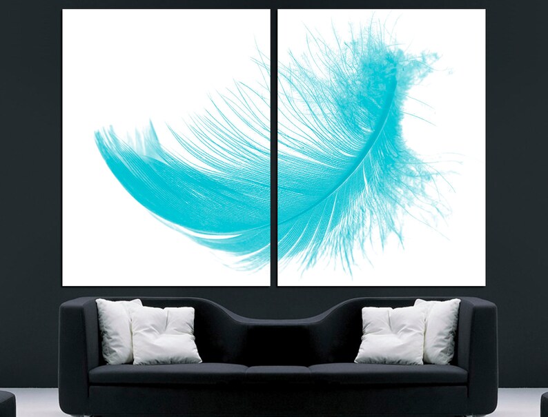 May include: A single, large, turquoise feather on a white background. The feather is spread out and appears to be floating.