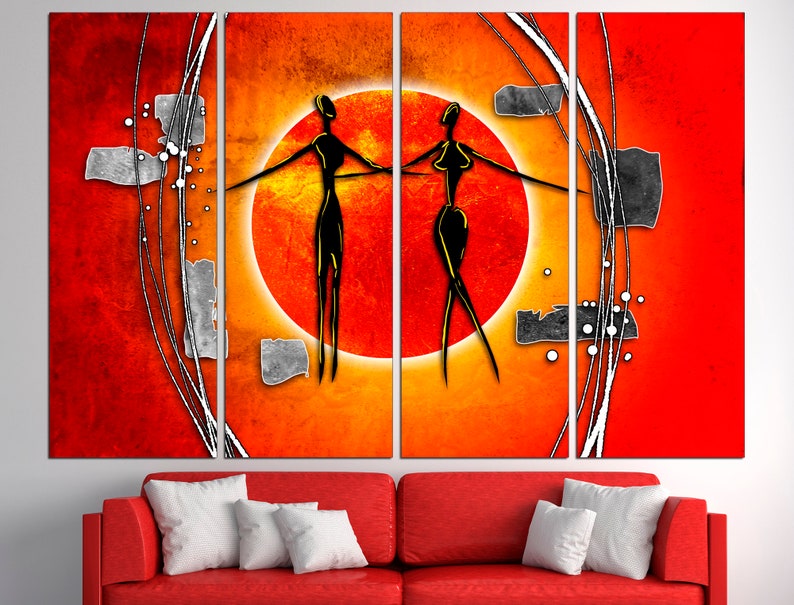 May include: Abstract art print featuring two stylized figures in black against a red and orange background with a large orange circle in the center.