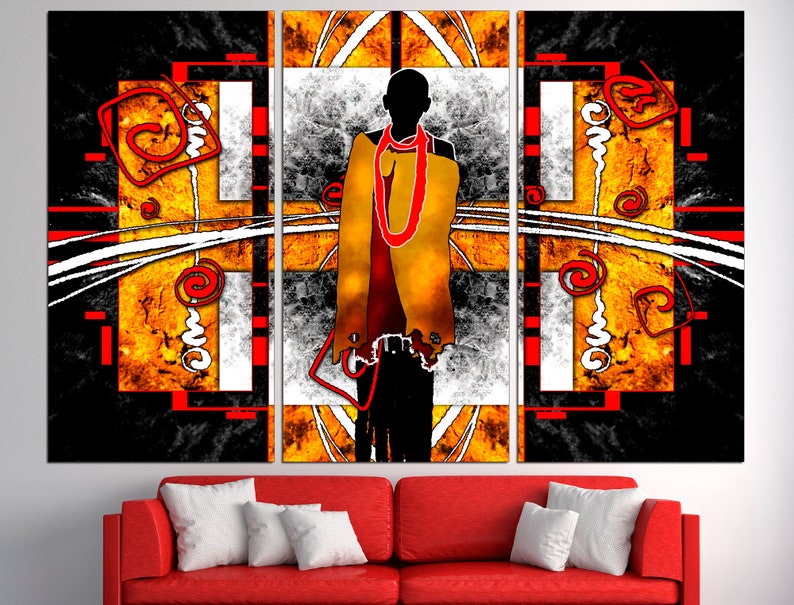 May include: Abstract art triptych featuring a silhouetted figure draped in yellow and red against a geometric background. The artwork incorporates black, white, and orange hues with red accents, creating a striking visual composition. The piece is displayed above a red sofa with white pillows.